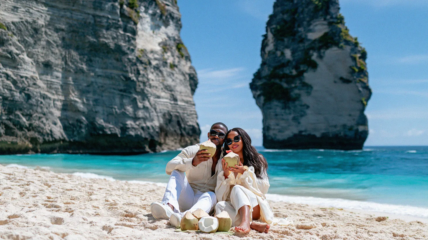 A couple with fresh coconuts in Bali